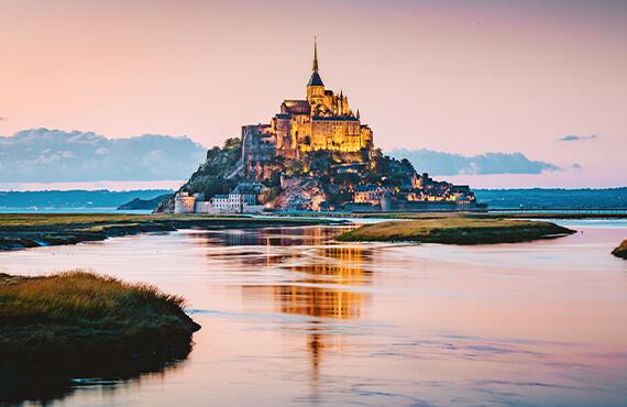 A view of Mont St Michel at low tide in the evening.