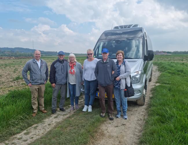 tour group standing by minibus