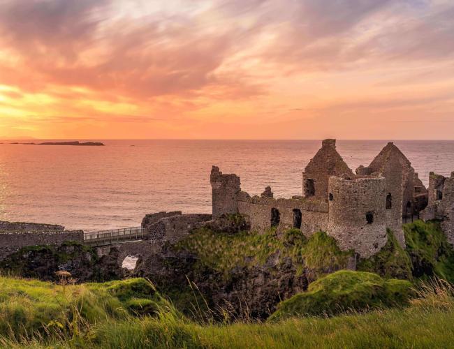 castle in ireland overlooking the sea at sunset