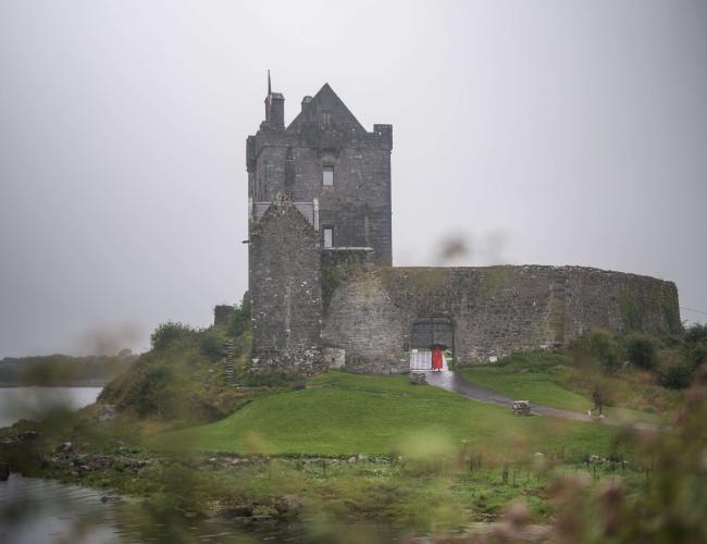 Dunguarie Castle in front of the misty, grey sky