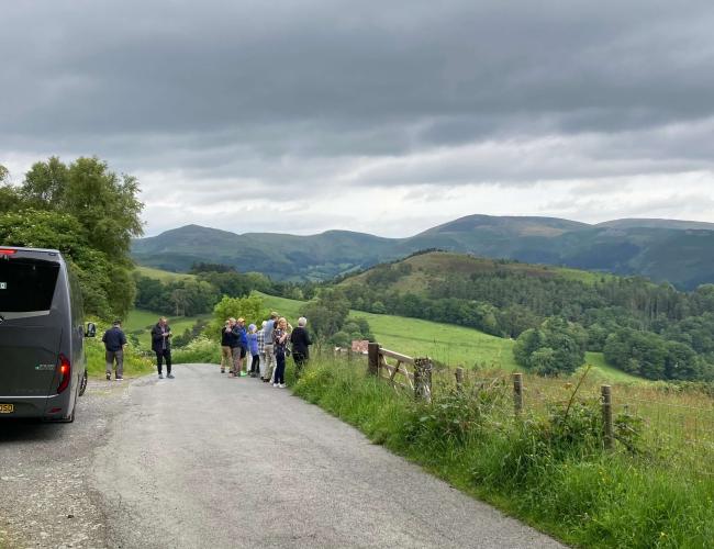 A small group of travellers embracing the beautiful scenery on a Back-Roads Highlights of Britain tour.