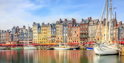 Boats moored at a harbor town in Normandy.
