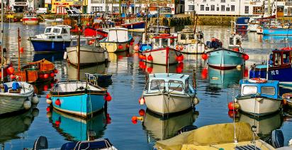 Small colorful boats in Cornwall harbor.