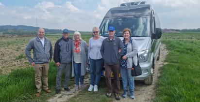 tour group standing by minibus
