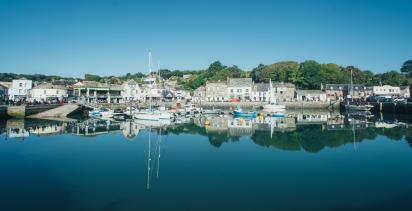 Padstow harbour, Cornwall, with fishing boats, shops and restaurants