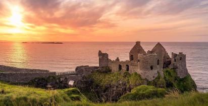 castle in ireland overlooking the sea at sunset