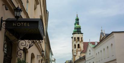 Kraków hotel entrance on the left of street view with church in background