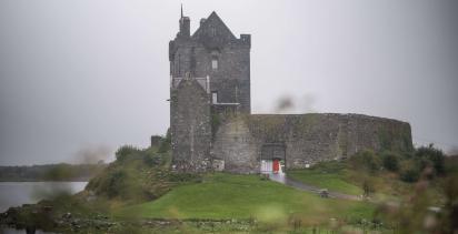 Dunguarie Castle in front of the misty, grey sky