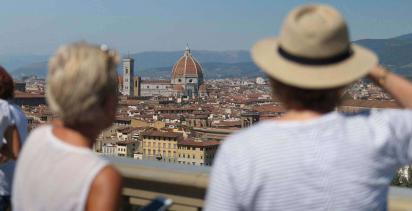 Man and woman overlooking the city of Florence with Florence Duomo in centre