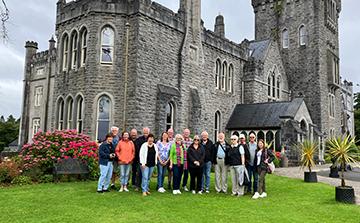 A tour group posing for a picture on The Emerald Isle tour.