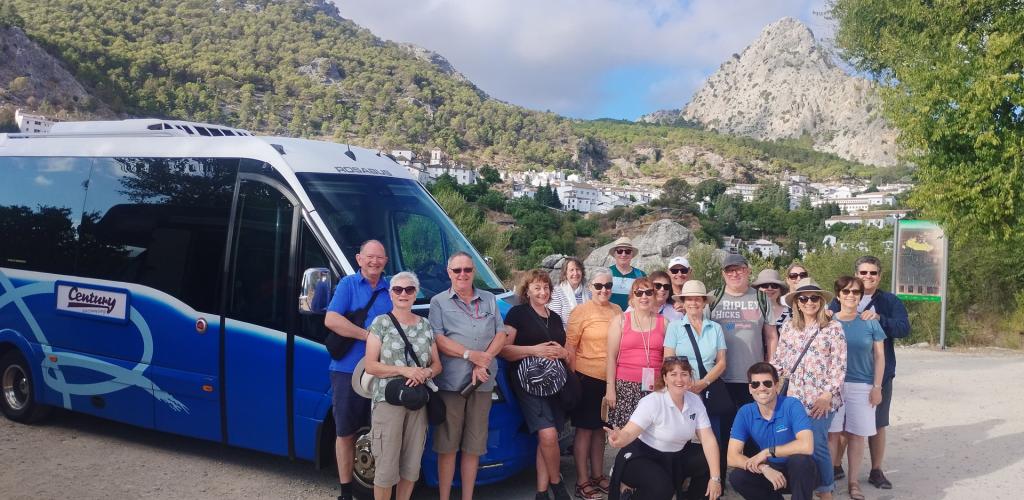Group posing in front of tour bus