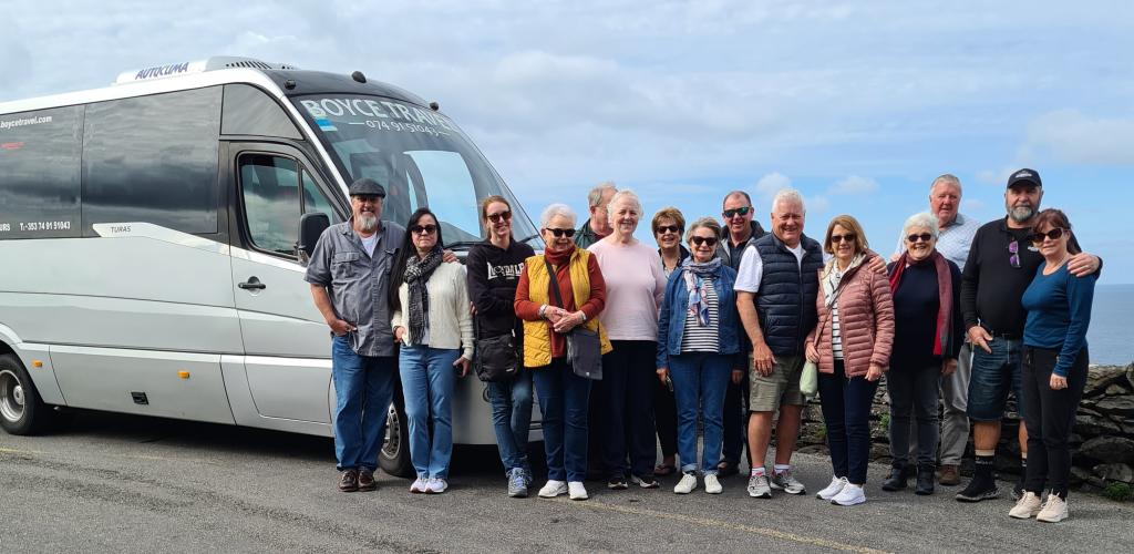 Group standing next to tour bus