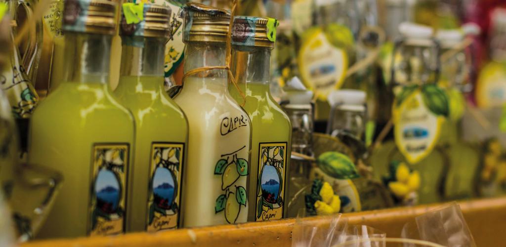 home made lemonchello in small bottles on a store shelf