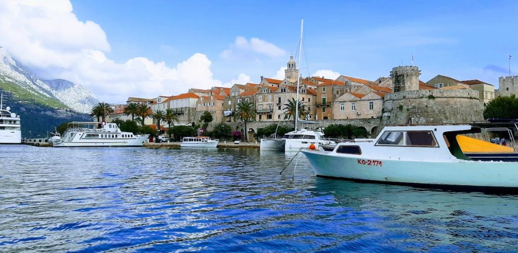 the old town of Korcula, Croatia, viewed from the water with boats in the harbour