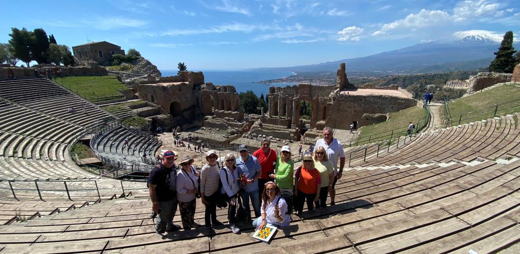 Group of people on steps of ancient Roman theatre