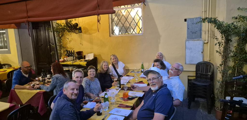 Group having dinner outside in Tuscany