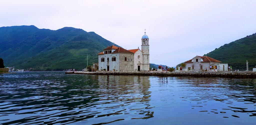 view from the water of Our Lady of the Rocks islet and the surrounding hills, Kotor, Montenegro