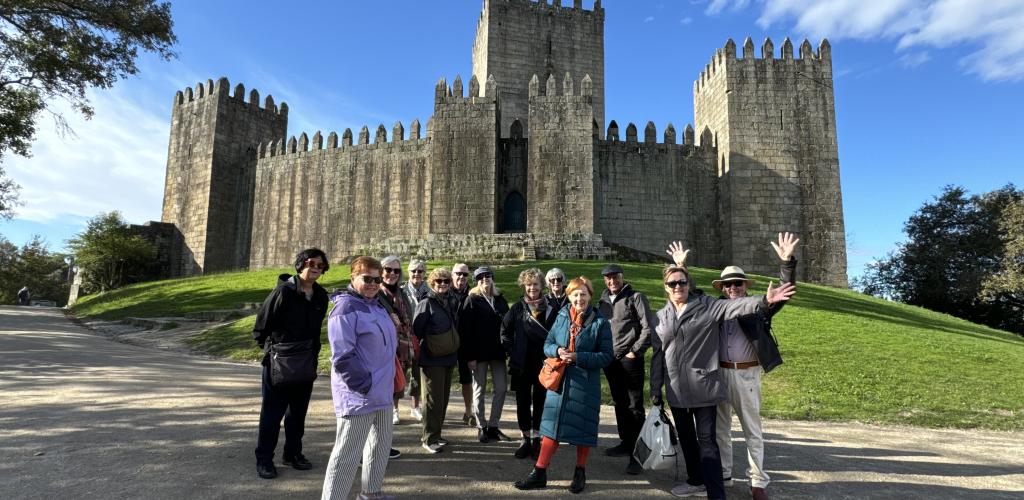 Group posing outside castle
