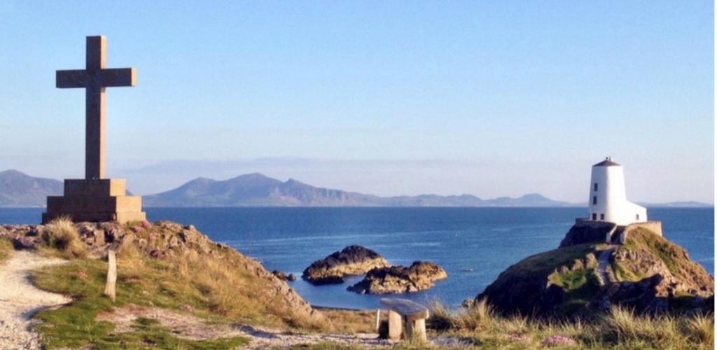 view of Llanddwyn Island, North Wales, with a cross monument