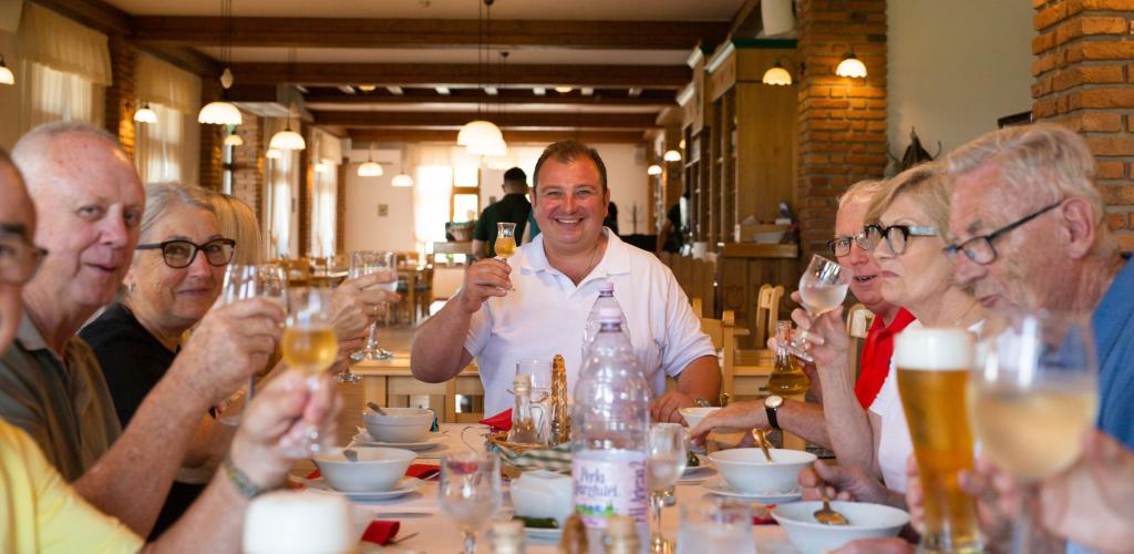 Tour Leader and guests eating dinner in Romania